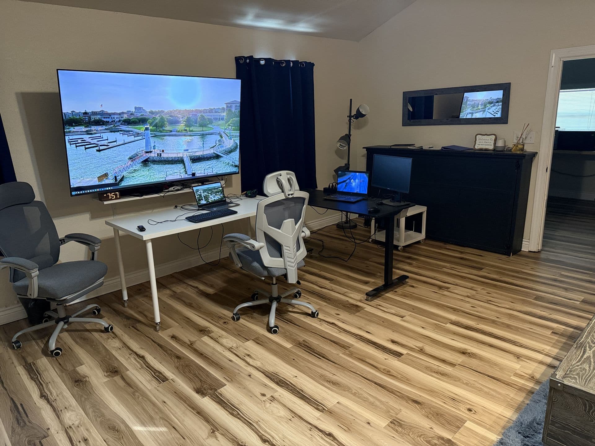 Dual workstation setup with large monitor and ergonomic chairs